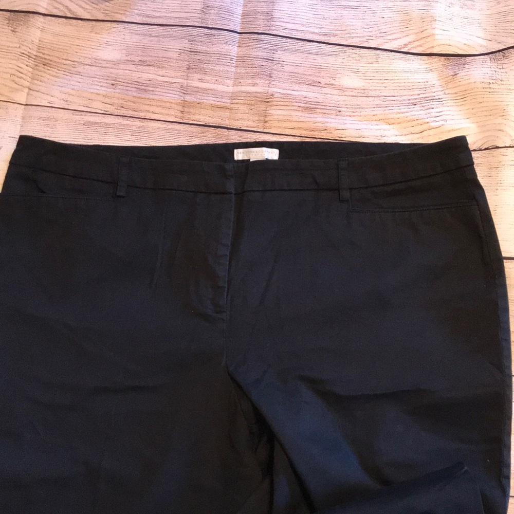 Women’s black, tall boot cut pants.